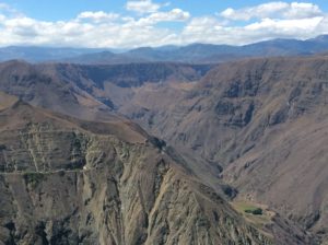 After dropping to the tunnel and beyond, you climb to, and follow, the dark plateau in the upper middle of the photo.