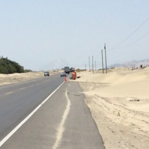 These guys are working with wheel barrows and shovels to stem a sand tide. 